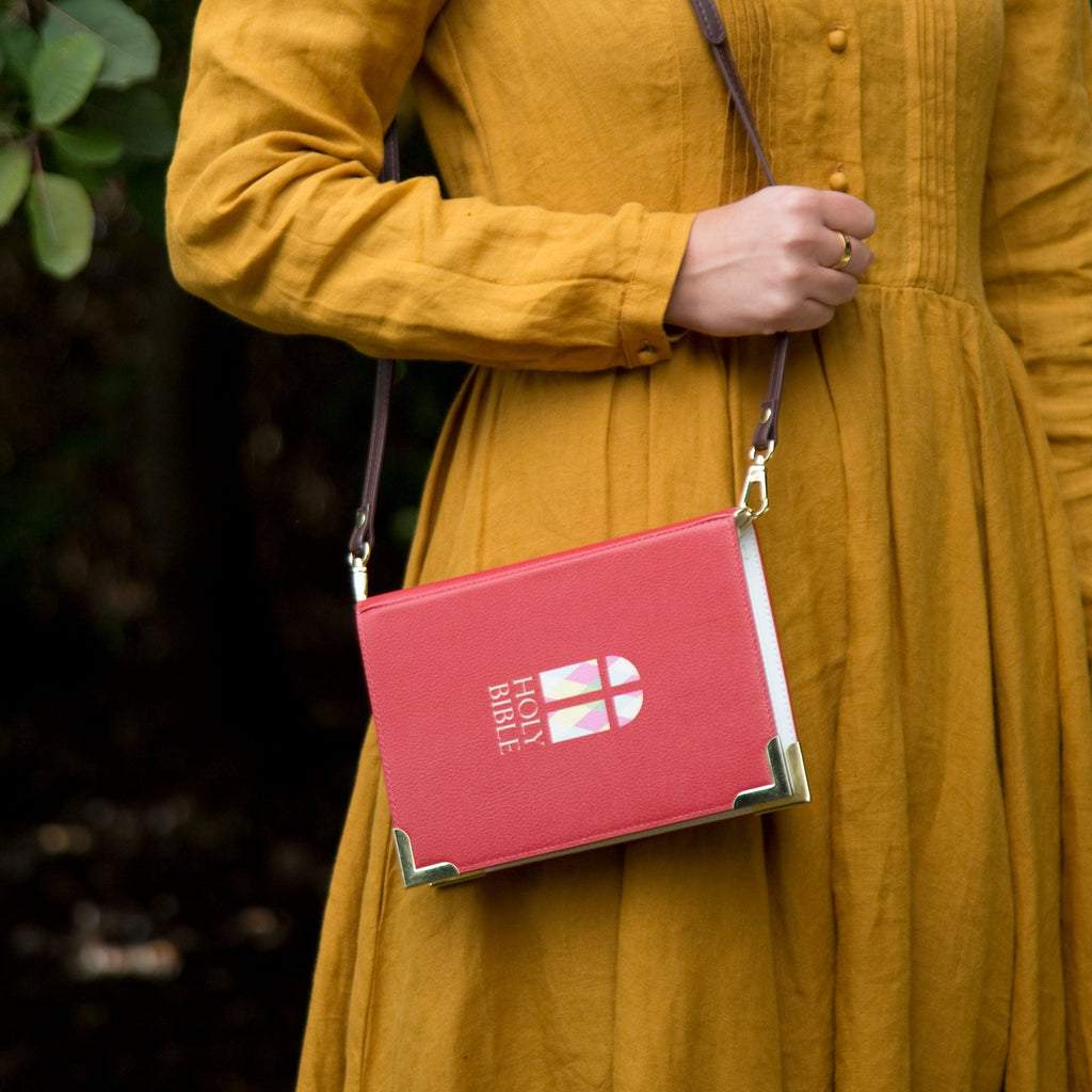 The Holy Bible Red Handbag by Well Read Co. featuring Stained-Glass Window design - Model in Yellow Dress