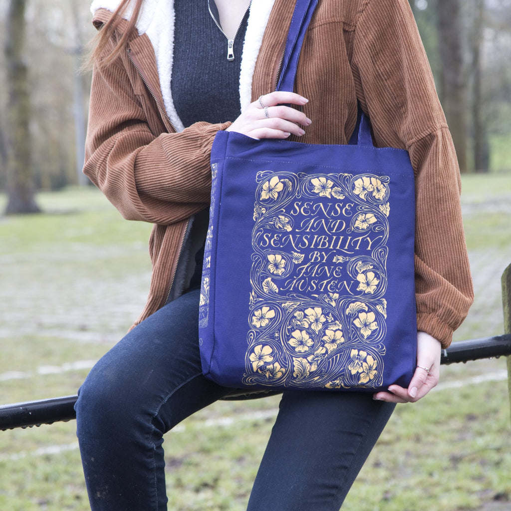 Sense and Sensibility Blue Tote Bag by Jane Austen featuring Gold Flower design, by Well Read Co. - Sitting