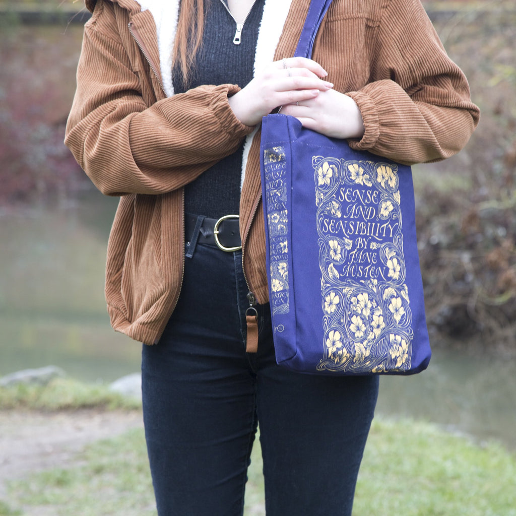 Sense and Sensibility Blue Tote Bag by Jane Austen featuring Gold Flower design, by Well Read Co. - Model